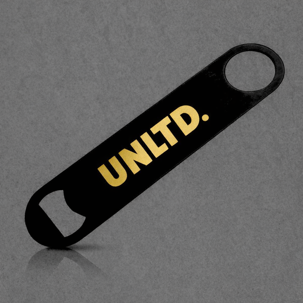 Black bottle opener with 'UNLTD.' in gold on a gray background