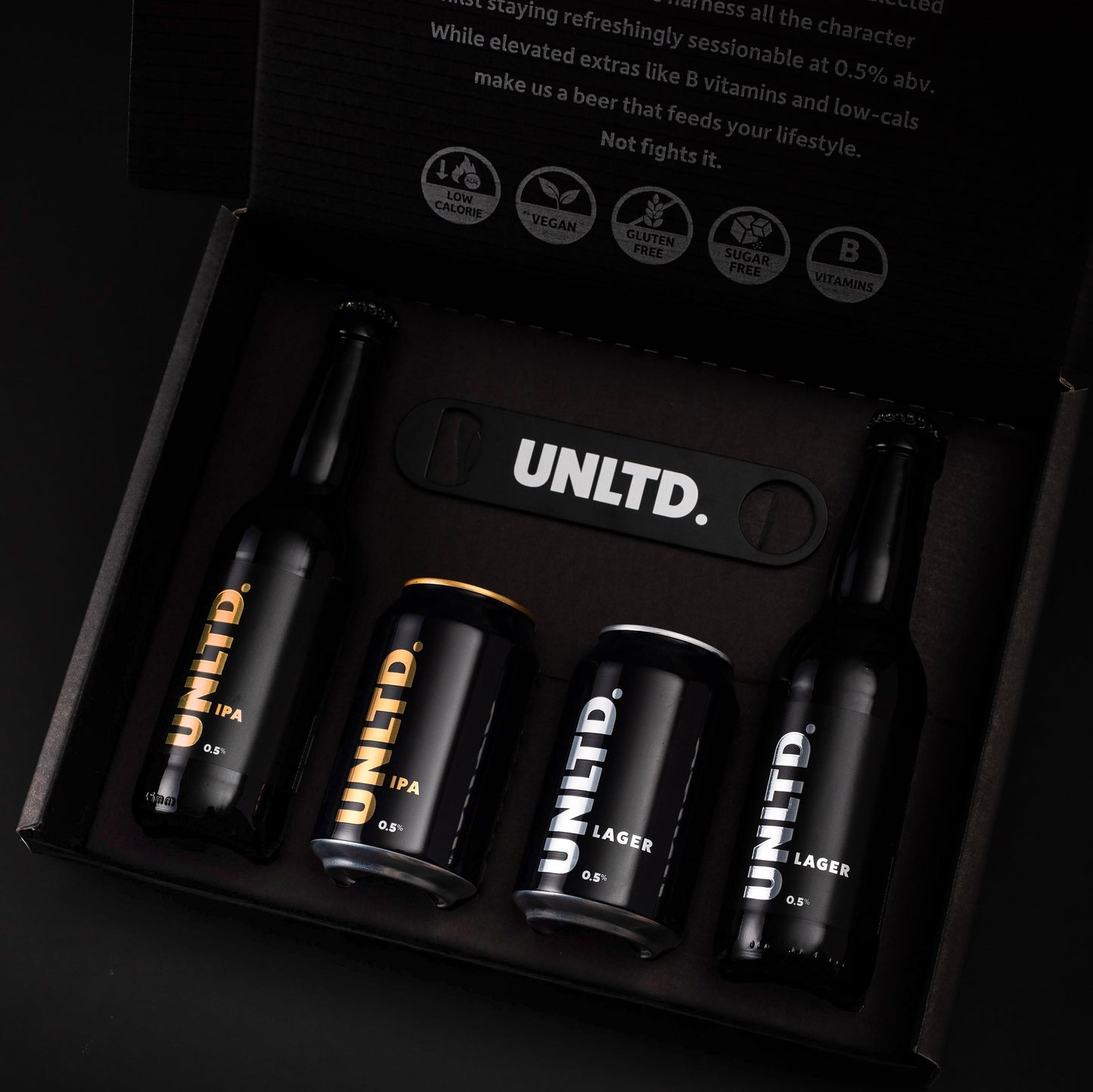 UNLTD beer bottles and cans in a box with brand logo